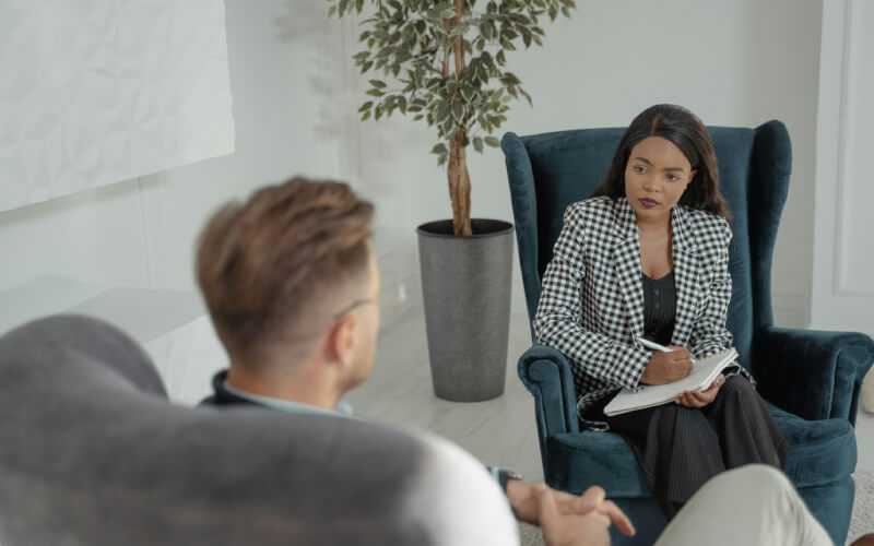 A therapists talking to a man