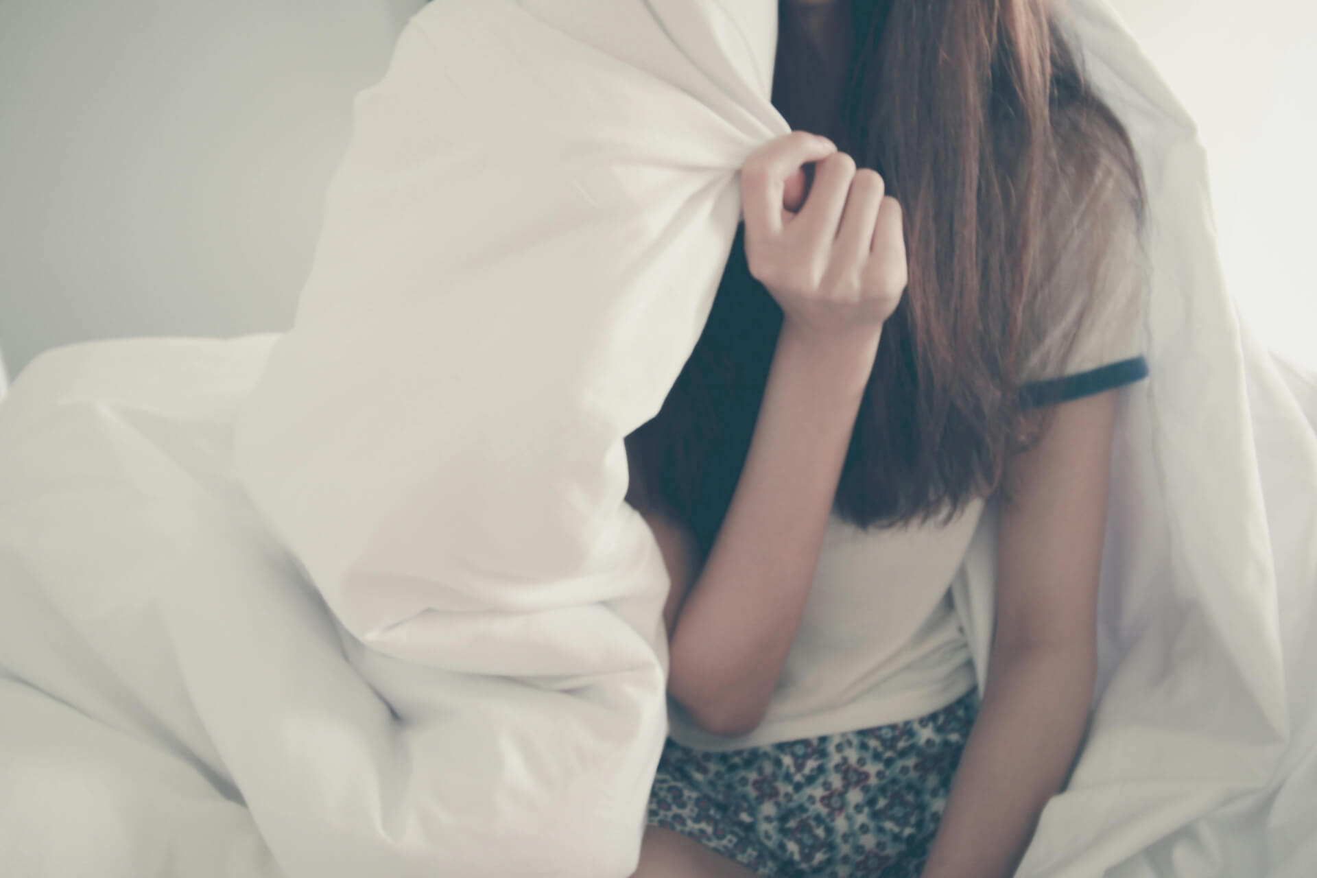 A girl covering in blanket