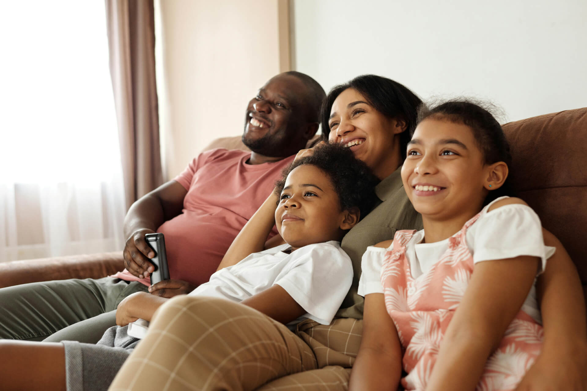 A family sitting on a couch