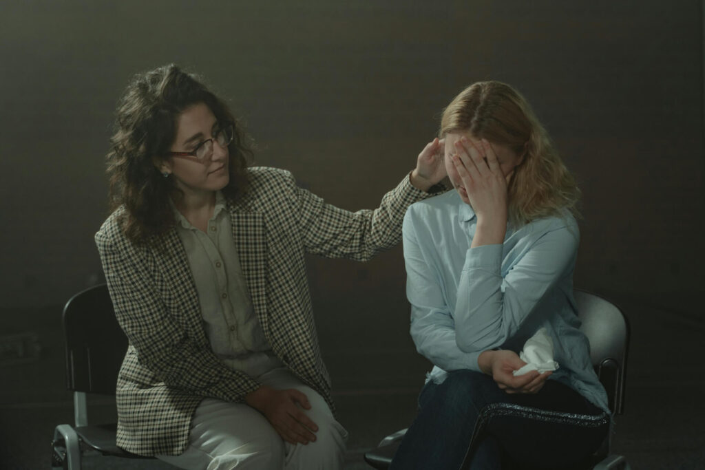 A therapists comforting a teen girl